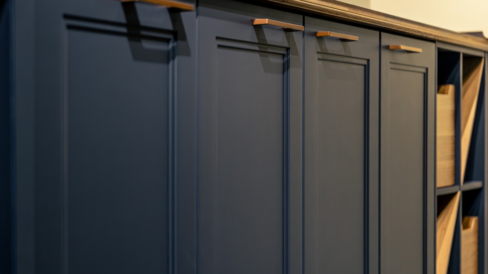Kitchen cabinet with its door removed, showing the existing box and face frame beside a new door sample